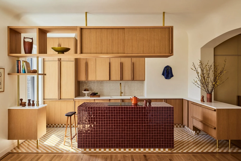Kitchen with natural wood cabinets, open shelving and a red tiled island